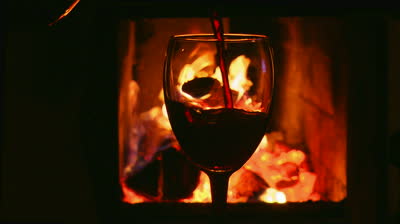 stock-footage-glass-of-wine-on-a-background-of-fire